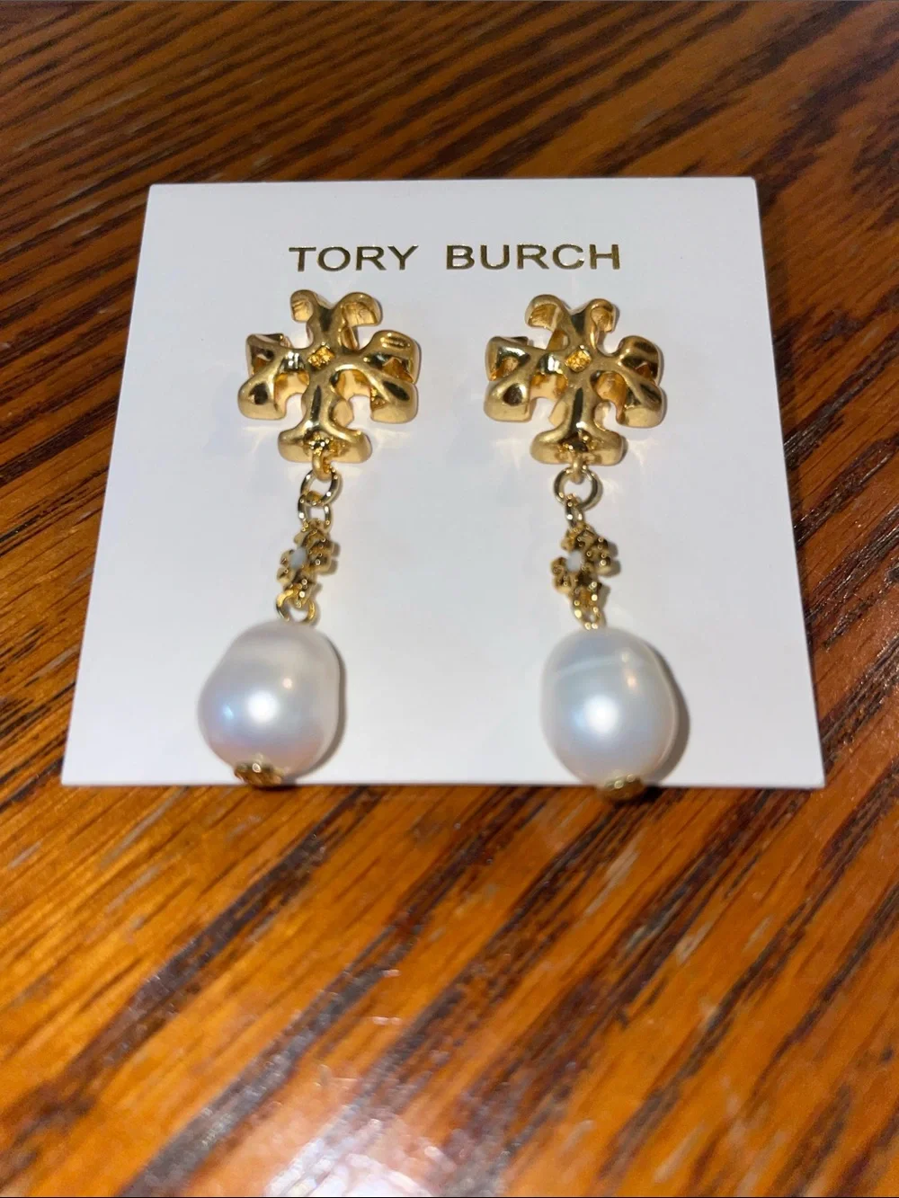 Brand new pearl-drop earrings by Tory Burch.